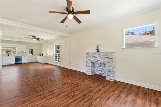 unfurnished living room featuring baseboards, dark wood-style flooring, a ceiling fan, and crown molding