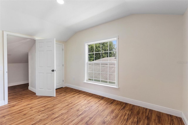 bonus room with baseboards and light wood finished floors