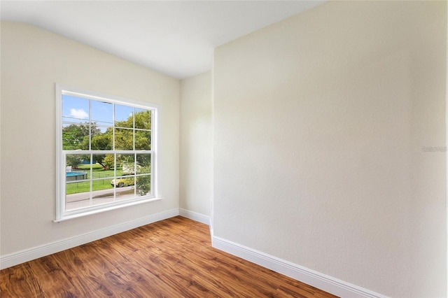 unfurnished room featuring wood finished floors and baseboards