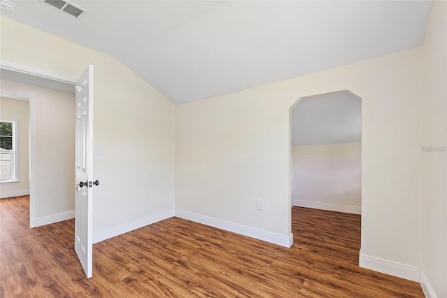 unfurnished room featuring visible vents, baseboards, and wood finished floors