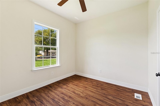 unfurnished room with visible vents, ceiling fan, baseboards, and dark wood-style flooring