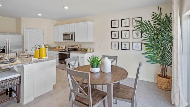 dining area featuring light tile patterned floors, baseboards, and recessed lighting