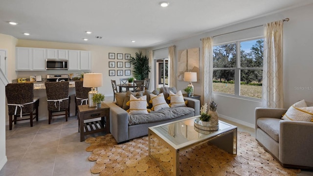 living room featuring recessed lighting, baseboards, and light tile patterned floors