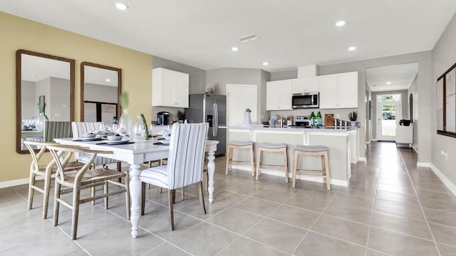 dining area with recessed lighting, light tile patterned floors, baseboards, and visible vents