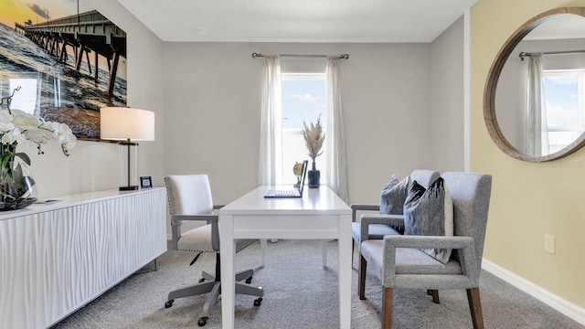 carpeted home office featuring baseboards