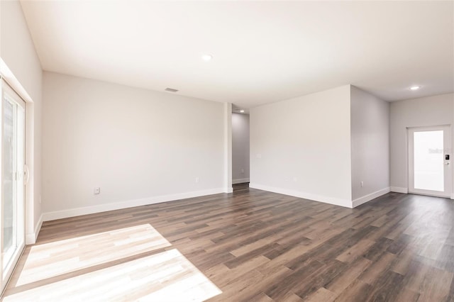 spare room featuring visible vents, recessed lighting, dark wood-style floors, and baseboards