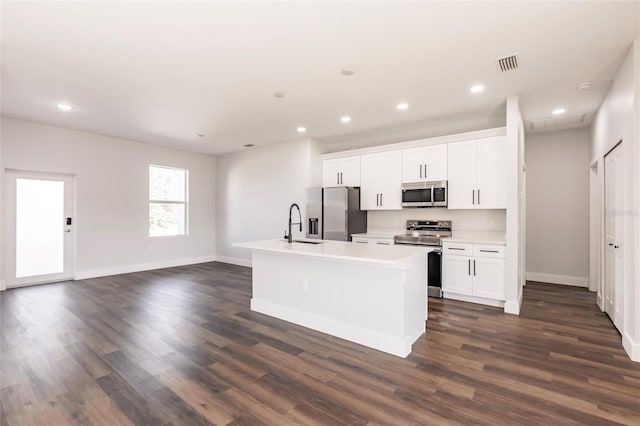 kitchen with visible vents, a center island with sink, recessed lighting, stainless steel appliances, and dark wood-style flooring