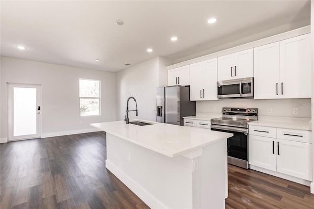 kitchen featuring a sink, stainless steel appliances, an island with sink, and recessed lighting