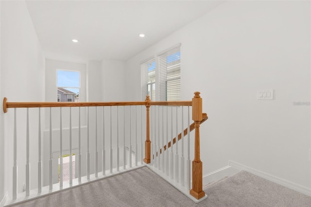 corridor featuring an upstairs landing, recessed lighting, baseboards, and carpet floors