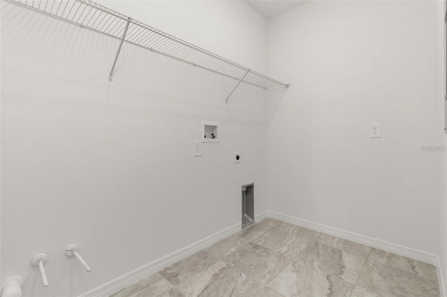 washroom featuring marble finish floor, baseboards, hookup for an electric dryer, hookup for a washing machine, and laundry area