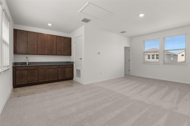 interior space featuring a sink, visible vents, light carpet, and recessed lighting