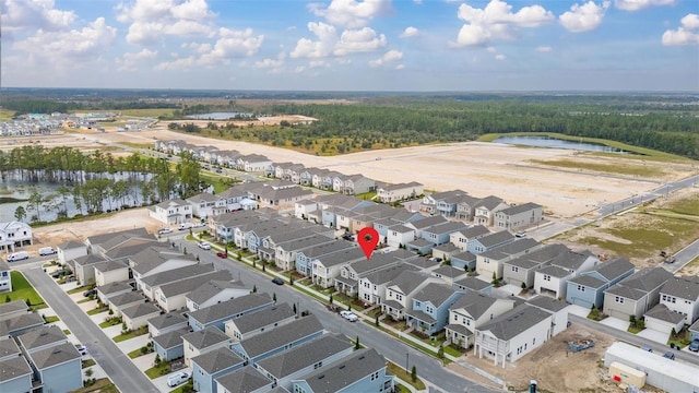 birds eye view of property featuring a water view and a residential view