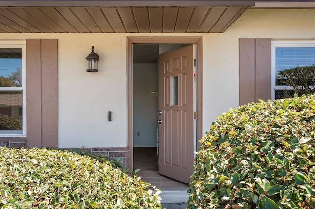 property entrance featuring stucco siding