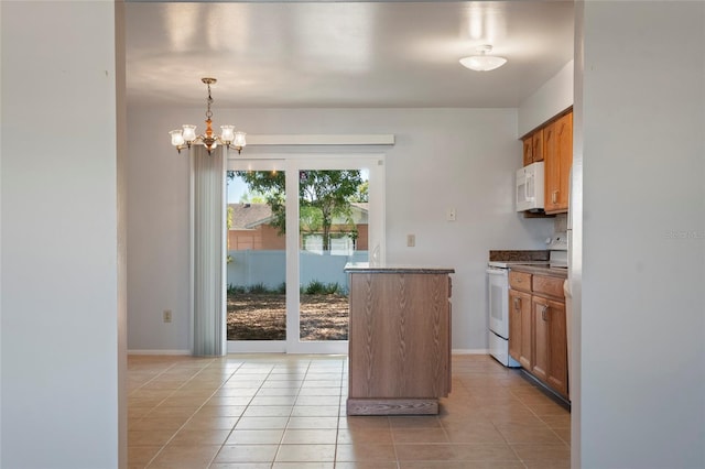 kitchen with white appliances, brown cabinetry, baseboards, light tile patterned flooring, and a notable chandelier