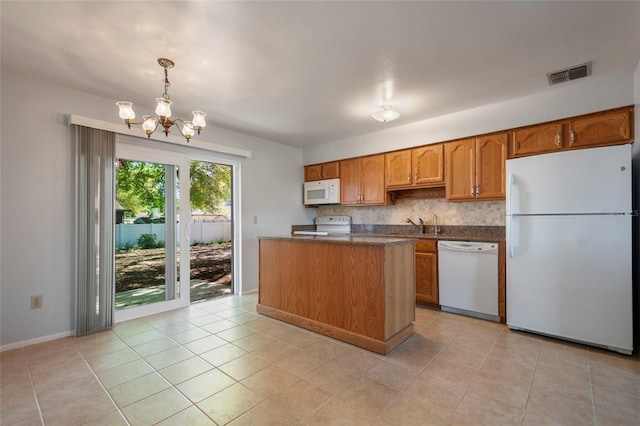 kitchen featuring visible vents, brown cabinets, a notable chandelier, dark countertops, and white appliances