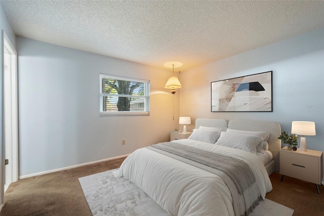 carpeted bedroom featuring a textured ceiling and baseboards