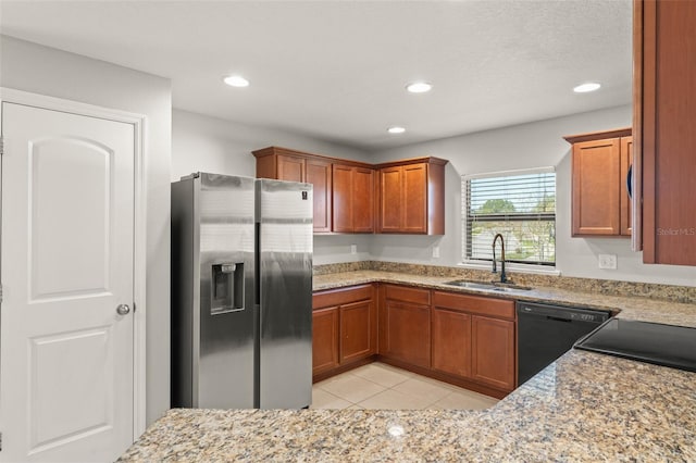 kitchen featuring dishwasher, brown cabinets, stainless steel refrigerator with ice dispenser, and a sink