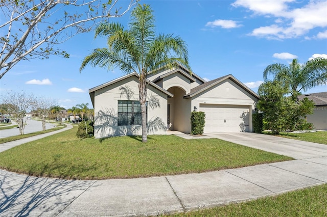 view of front facade featuring stucco siding, an attached garage, concrete driveway, and a front yard