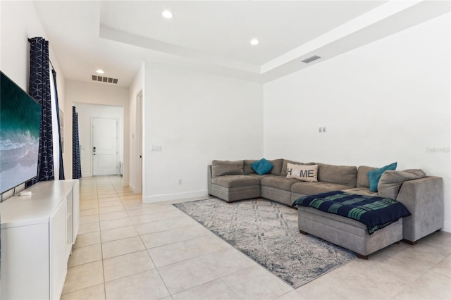 living room featuring recessed lighting, visible vents, a raised ceiling, and light tile patterned flooring