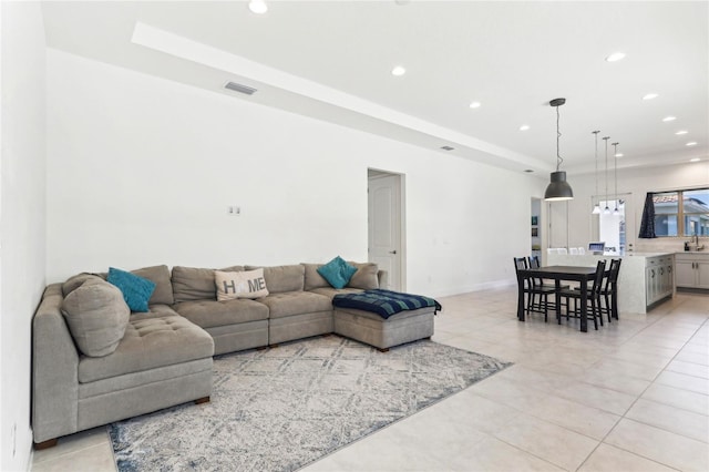 living area with recessed lighting, visible vents, baseboards, and light tile patterned floors