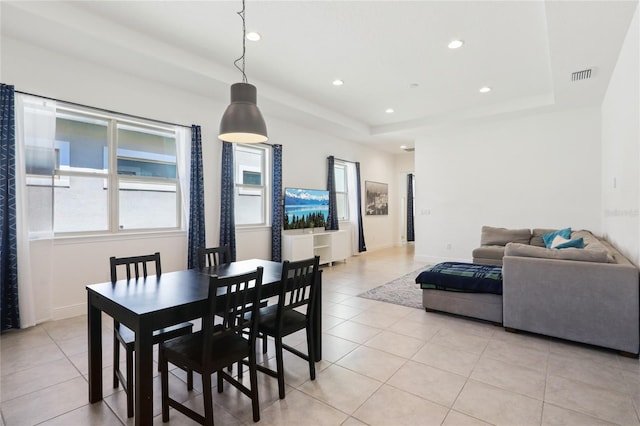 dining room featuring light tile patterned floors, visible vents, recessed lighting, and a raised ceiling