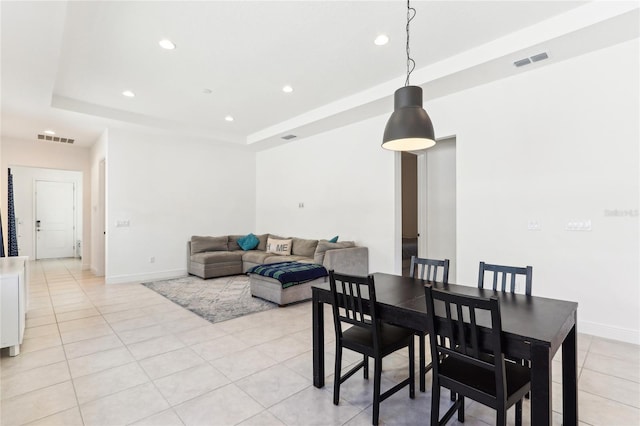 dining room with light tile patterned floors, visible vents, recessed lighting, and a tray ceiling