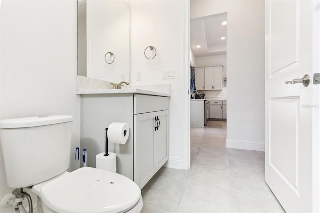 bathroom featuring tile patterned flooring, baseboards, toilet, recessed lighting, and vanity