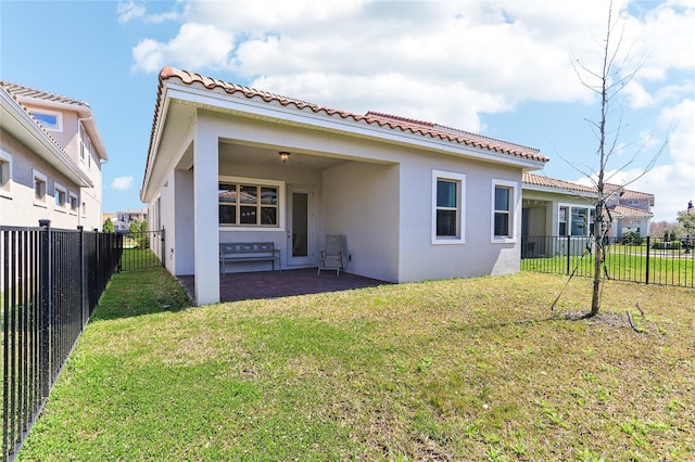 rear view of house featuring stucco siding, a patio, a lawn, and a fenced backyard