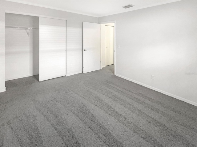 unfurnished bedroom with visible vents, baseboards, carpet, and a closet