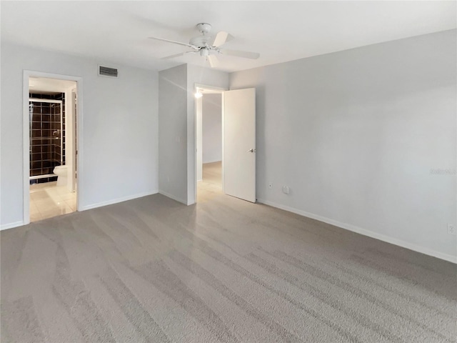 spare room featuring visible vents, baseboards, ceiling fan, and carpet floors