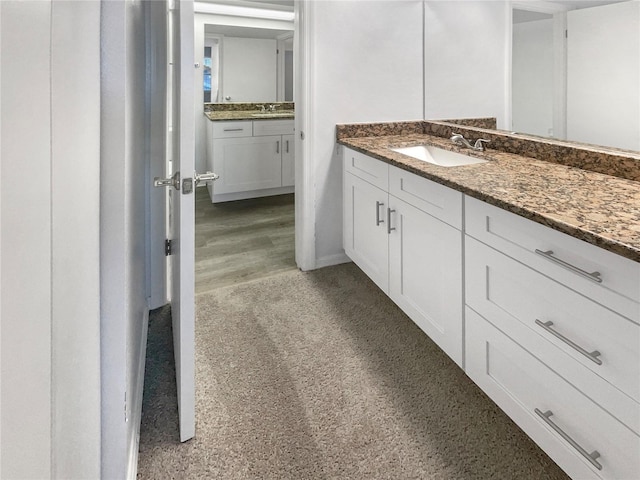 bathroom featuring a sink and two vanities