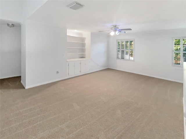 spare room featuring visible vents, baseboards, carpet, and ceiling fan