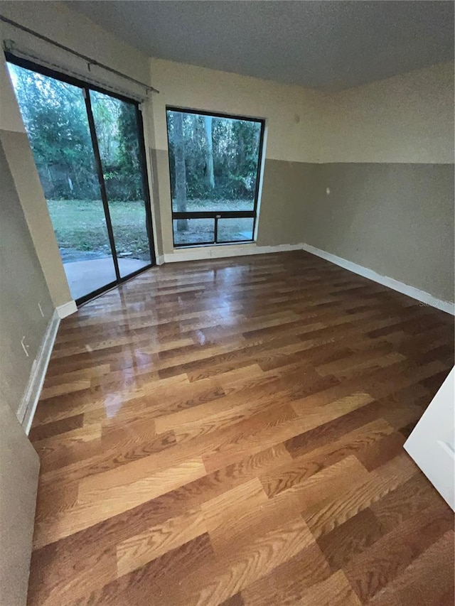 empty room with wood finished floors and baseboards