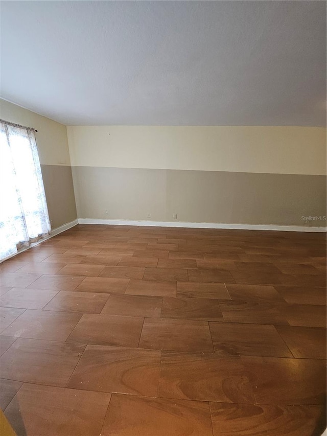 spare room with baseboards