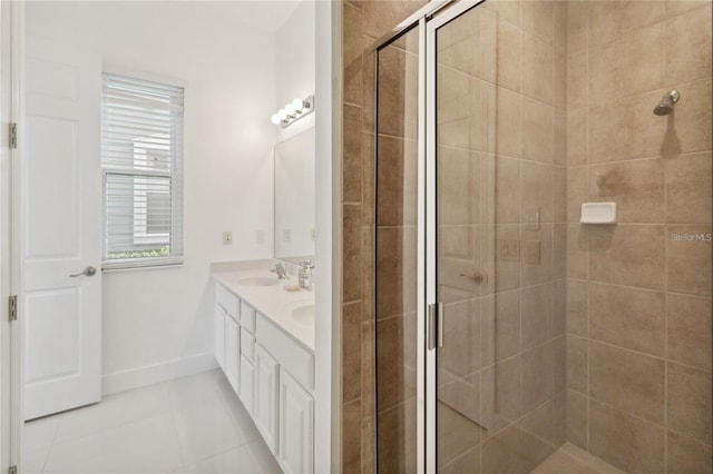 full bathroom featuring tile patterned floors, baseboards, a stall shower, and double vanity