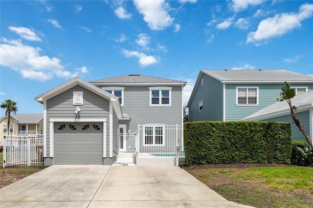 traditional home featuring an attached garage, metal roof, driveway, and fence