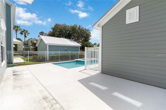 view of swimming pool with a patio, a pool with connected hot tub, and fence