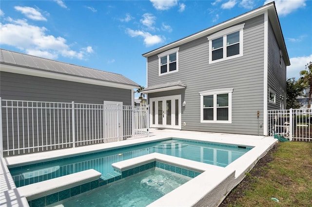 rear view of house featuring a patio, french doors, an in ground hot tub, and fence