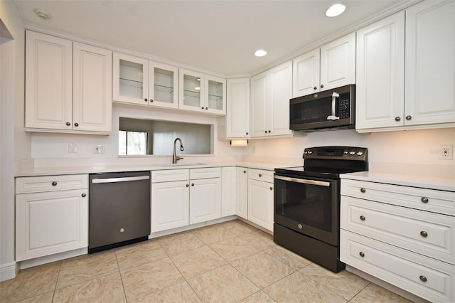 kitchen with dishwasher, light countertops, black range with electric stovetop, and a sink