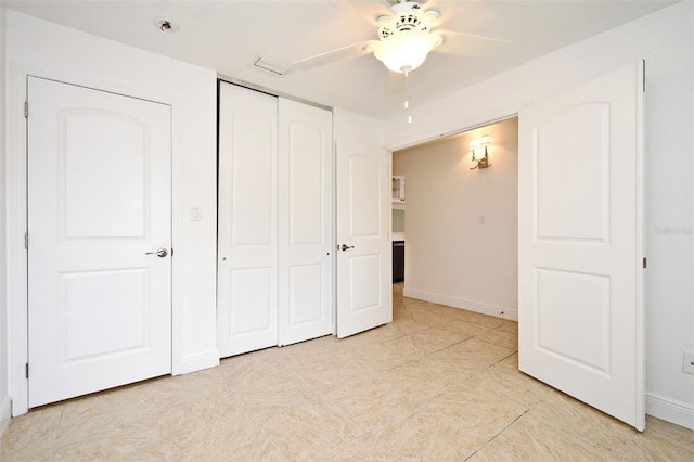 unfurnished bedroom featuring a closet, baseboards, visible vents, and a ceiling fan