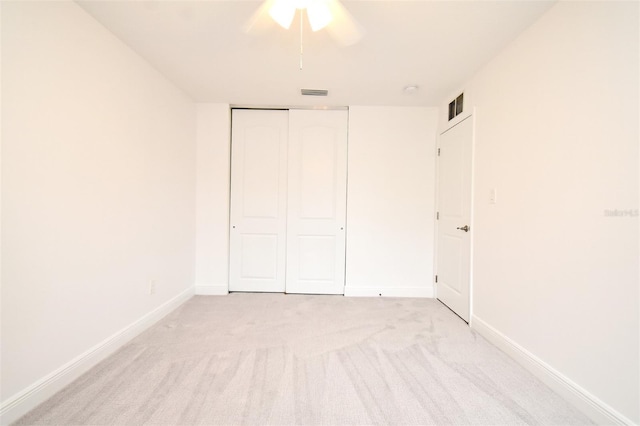 unfurnished bedroom with light carpet, visible vents, and baseboards