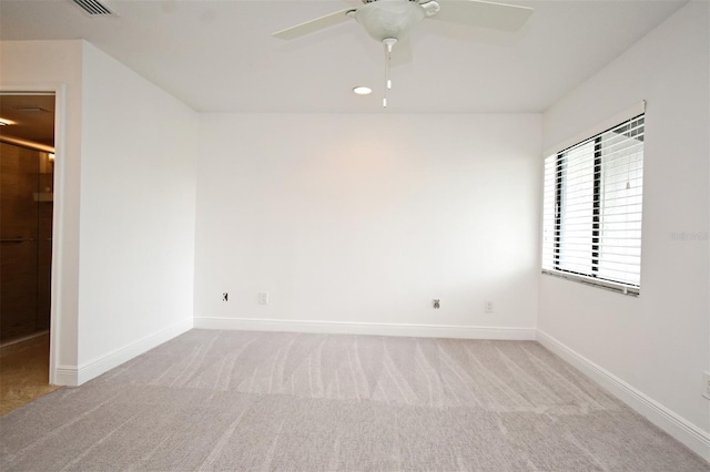 empty room with carpet flooring, baseboards, and a ceiling fan