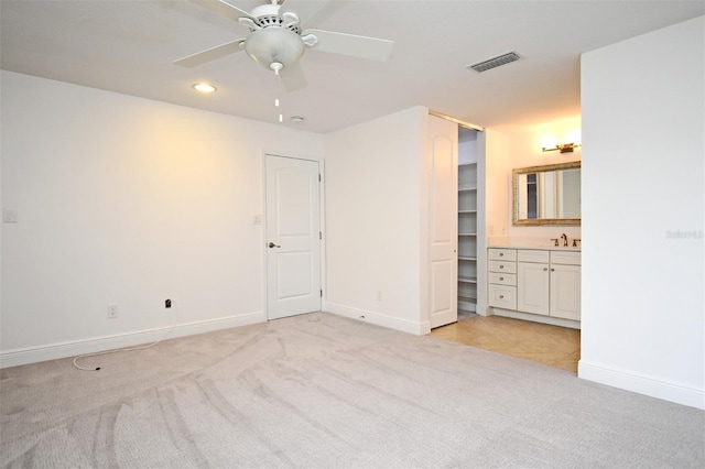 unfurnished bedroom featuring light colored carpet, visible vents, and baseboards