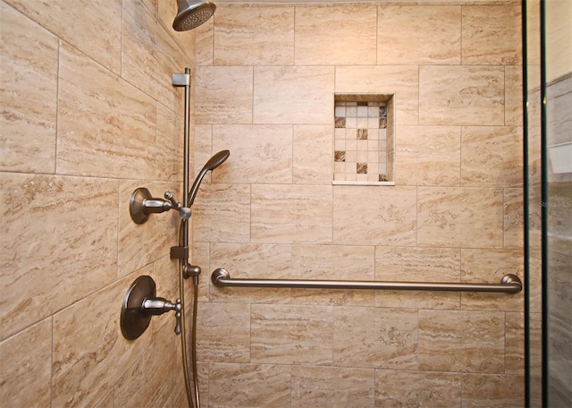 interior details featuring tiled shower