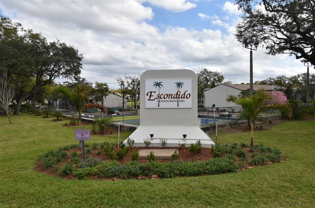 community / neighborhood sign with a lawn