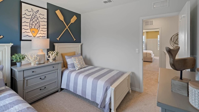 bedroom with visible vents and light colored carpet