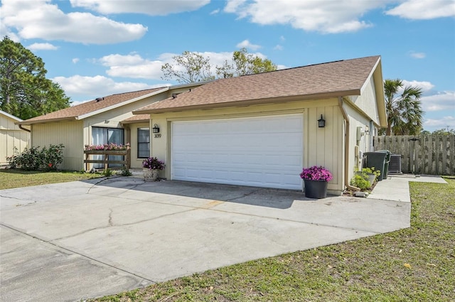 ranch-style home featuring a garage, cooling unit, roof with shingles, and fence