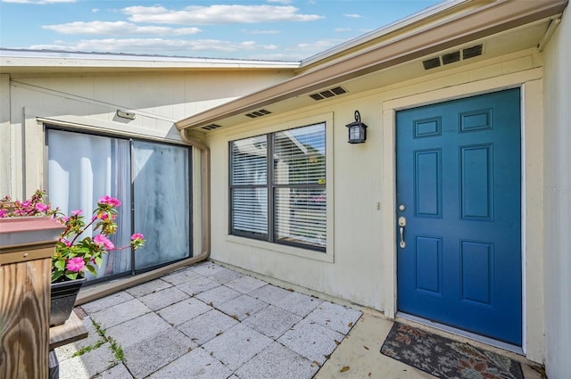 property entrance featuring a patio