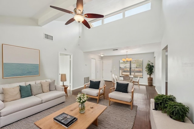 living area with ceiling fan with notable chandelier, wood finished floors, visible vents, and baseboards