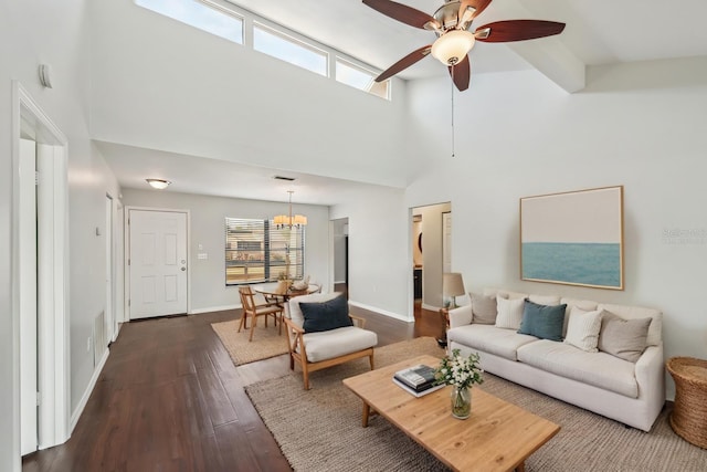 living area featuring visible vents, a ceiling fan, baseboards, a towering ceiling, and dark wood-style flooring